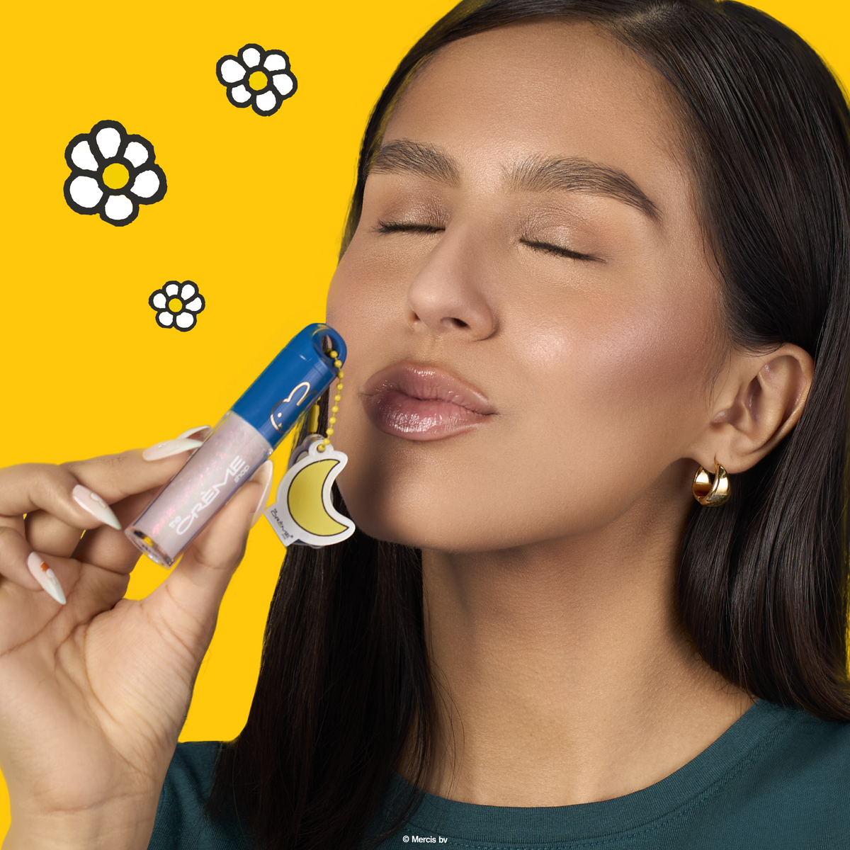 Miffy Tinted Lip Oil — model holding a blue-capped lip oil beside her face
