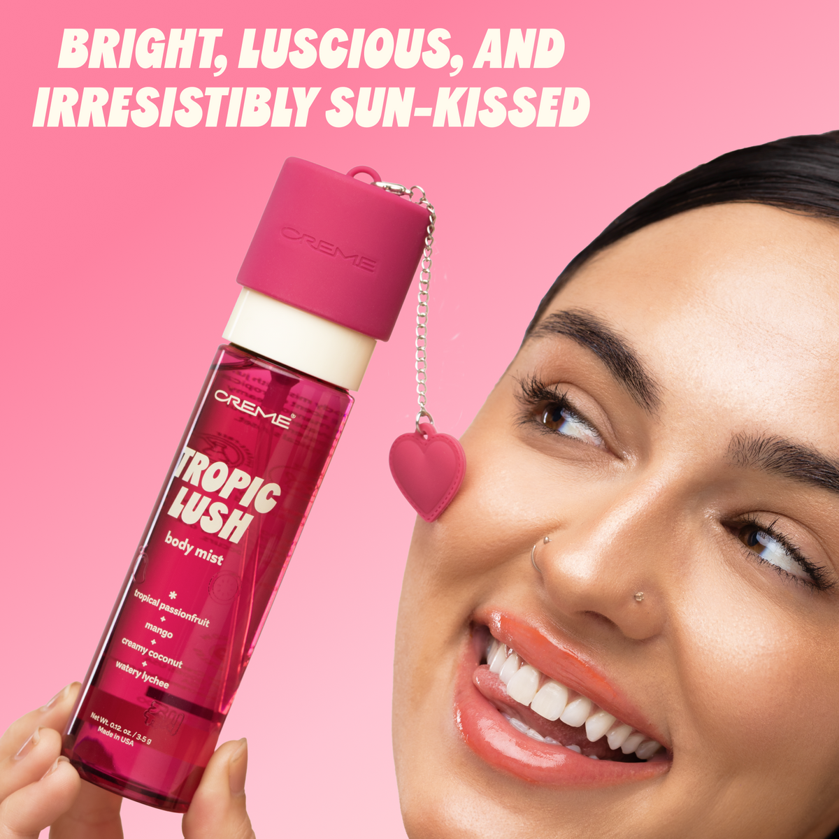 Tropic Lush Body Mist — model holding the bottle beside her face
