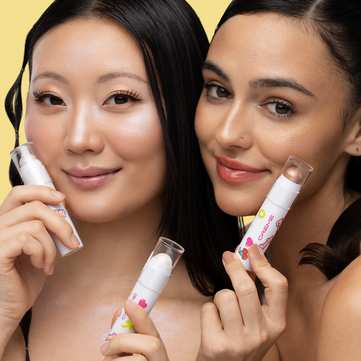 Aura Glow Highlighter — two models showing highlighted cheeks and holding sticks