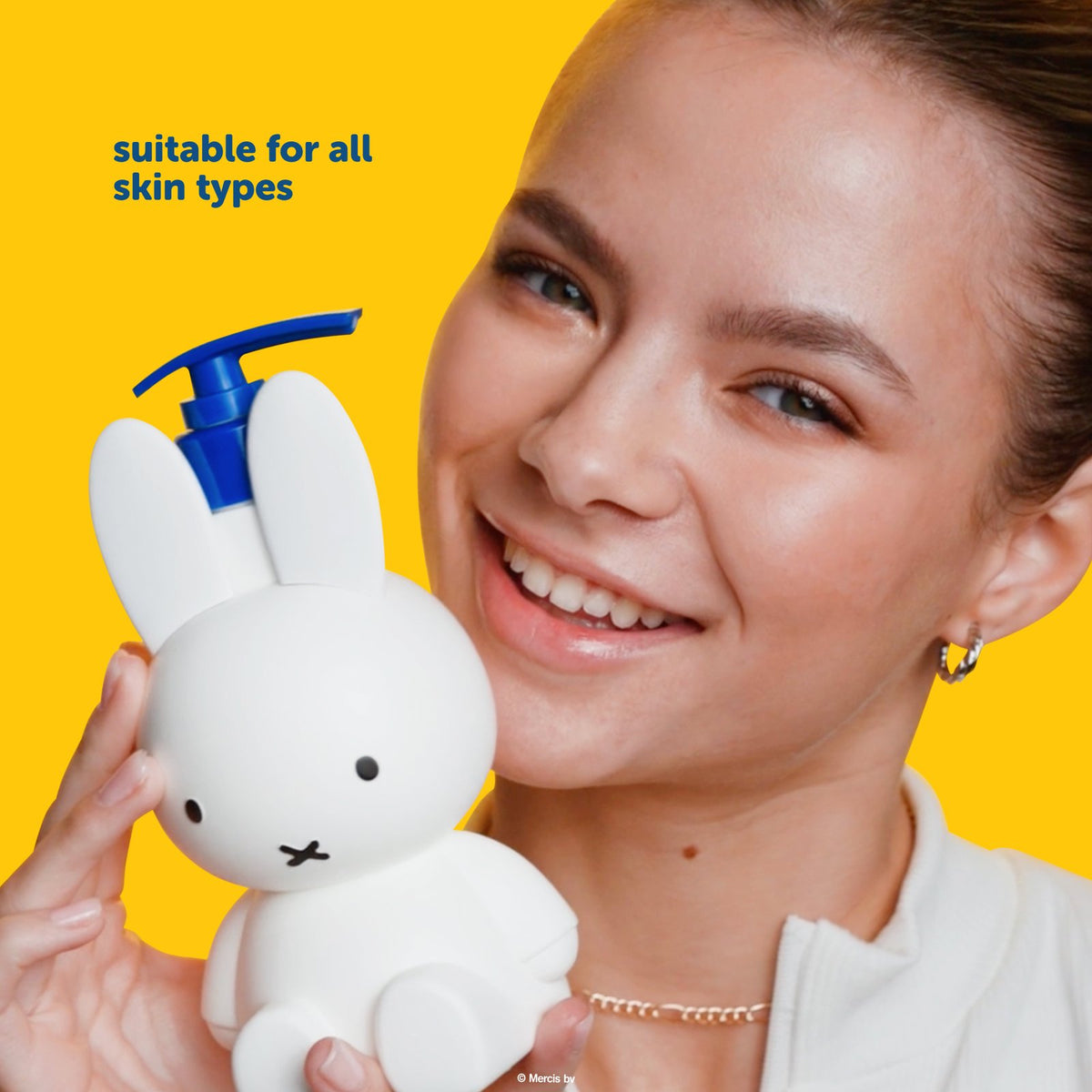 Miffy Flower Garden Body Lotion — model holding the Miffy body lotion bottle