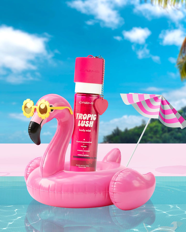 Tropic Lush body mist on a pink flamingo float beside an aqua pool